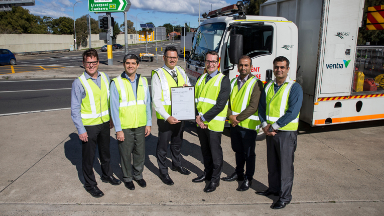 The M5 East Motorway team in high-visibility attire pictured with John Krnel from BSI (third from the right).